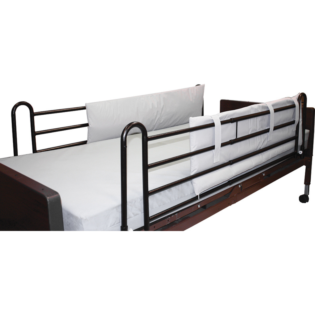 A hospital bed with dark metal side rails features a white mattress and Roscoe Full-Length Bed Rail Cushioned Pads—1 Pair—for added comfort and safety, including a white padded guard on one rail to help prevent accidents.